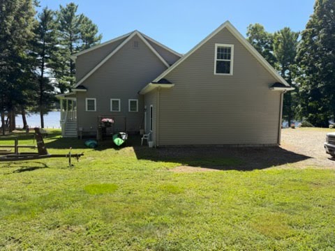 House siding before and after a soft wash — algae and grime removed, siding restored.