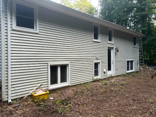 Home exterior before and after house washing — green film gone from the shaded side.