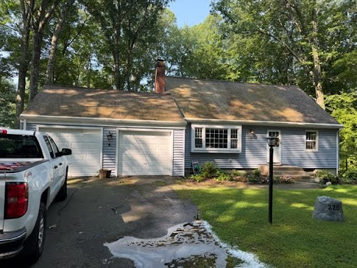 Weathered siding before and after a house wash — color and finish brought back.